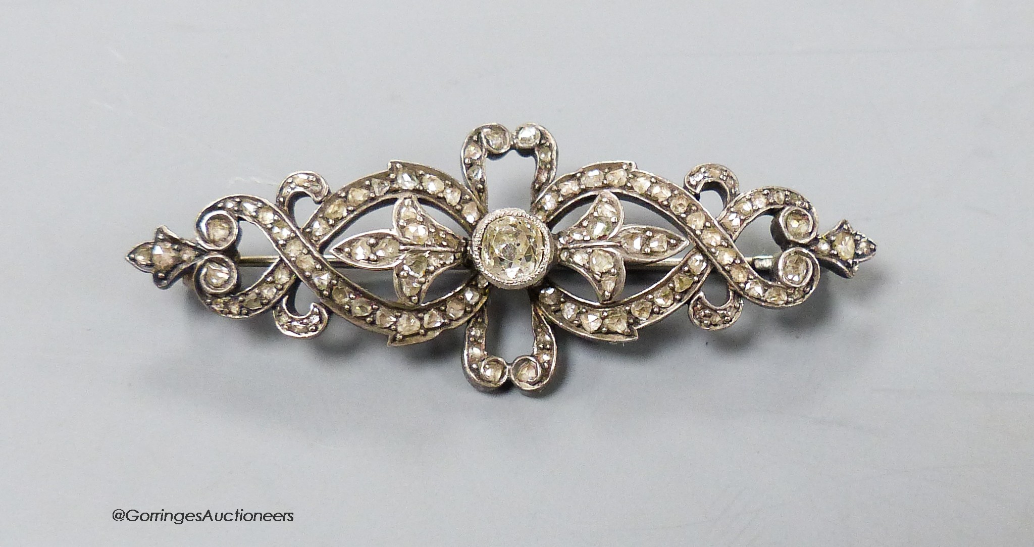 A Victorian white metal (probably silver?) and rose cut diamond encrusted openwork bar brooch, 49mm, gross 6.6 grams.
